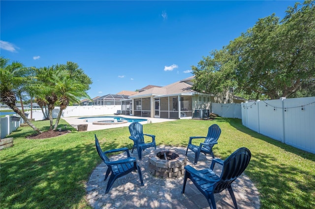 5102 Pheasant Woods Dr, Lutz, FL 33558 - fenced backyard featuring a fire pit, a sunroom, an in-ground hot tub, and a patio area