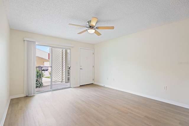 302 Lake Parsons Grn Unit 104, Brandon, FL 33511 - empty room featuring light wood-style flooring, ceiling fan, and a textured ceiling