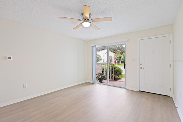 302 Lake Parsons Grn Unit 104, Brandon, FL 33511 - foyer featuring wood finished floors, a textured ceiling, and a ceiling fan