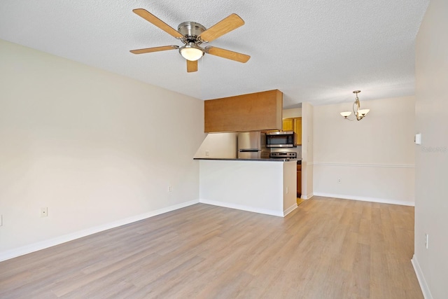 302 Lake Parsons Grn Unit 104, Brandon, FL 33511 - unfurnished living room featuring a chandelier, light wood finished floors, ceiling fan, and a textured ceiling