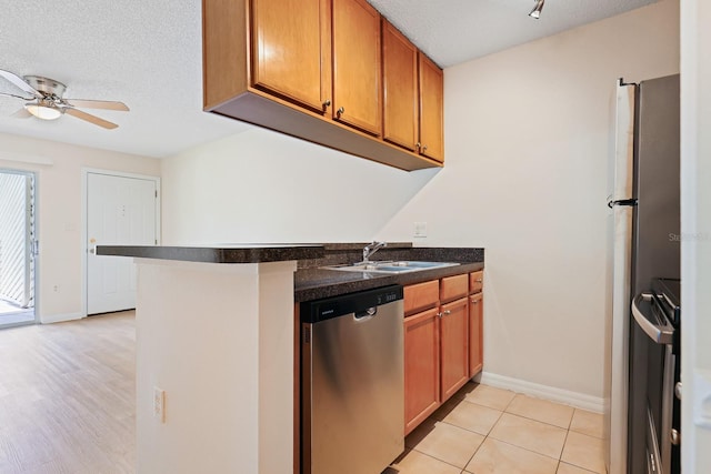 302 Lake Parsons Grn Unit 104, Brandon, FL 33511 - kitchen featuring dishwasher, dark countertops, ceiling fan, brown cabinets, and a textured ceiling