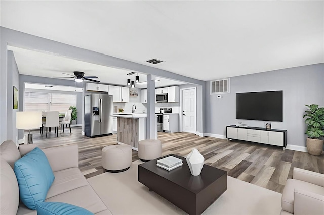 3330 Rock Royal Dr, Holiday, FL 34691 - living area featuring light wood-style floors and ceiling fan