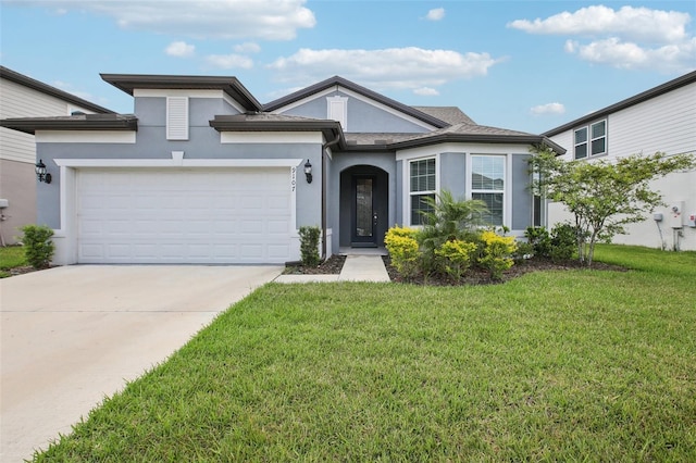 9107 Rally Spring Loop, Wesley Chapel, FL 33545 - view of front of house featuring stucco siding, a front lawn, concrete driveway, and a garage