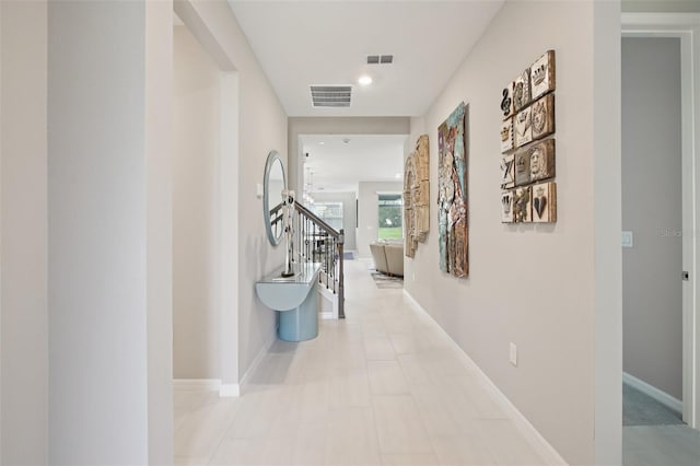 9107 Rally Spring Loop, Wesley Chapel, FL 33545 - hallway featuring stairway and baseboards