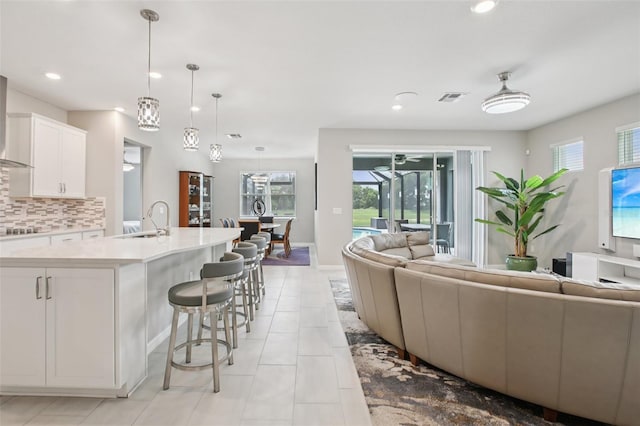 9107 Rally Spring Loop, Wesley Chapel, FL 33545 - kitchen with open floor plan, plenty of natural light, light countertops, backsplash, and recessed lighting