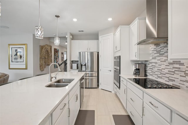 9107 Rally Spring Loop, Wesley Chapel, FL 33545 - kitchen featuring wall chimney range hood, appliances with stainless steel finishes, light countertops, decorative backsplash, and recessed lighting