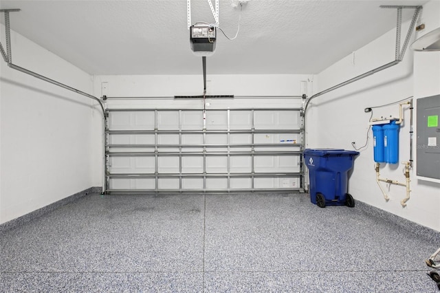 9107 Rally Spring Loop, Wesley Chapel, FL 33545 - garage with a garage door opener and baseboards