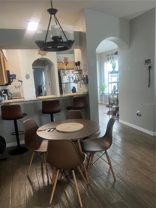 7719 Carriage Pointe Dr, Gibsonton, FL 33534 - dining room with arched walkways and wood finish floors