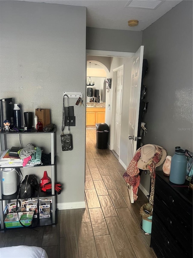 7719 Carriage Pointe Dr, Gibsonton, FL 33534 - hallway featuring wood finished floors and arched walkways