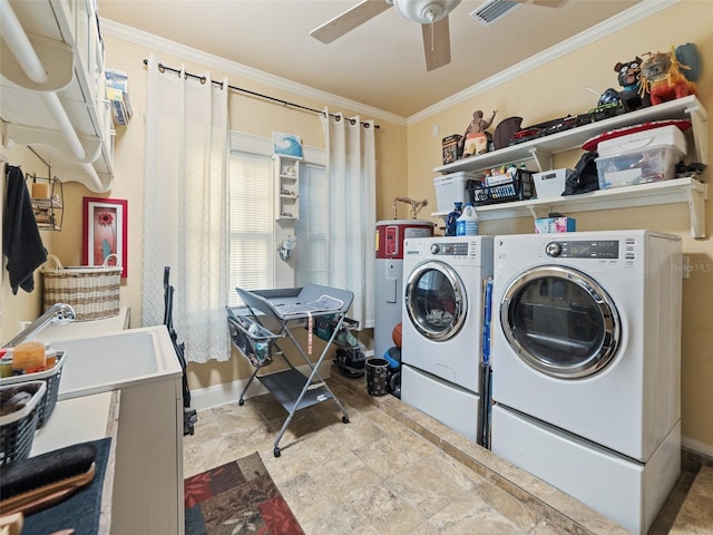 2504 W N A St Unit A, Tampa, FL 33609 - laundry area featuring washer and dryer, water heater, ornamental molding, stone finish floors, and ceiling fan