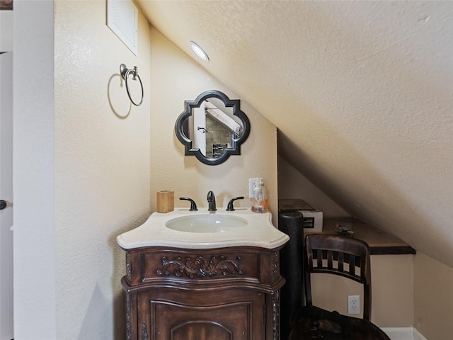 2504 W N A St Unit A, Tampa, FL 33609 - bathroom featuring vaulted ceiling, a textured ceiling, and vanity