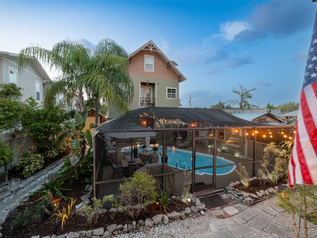 2504 W N A St Unit A, Tampa, FL 33609 - back of property featuring an outdoor pool, a patio, and glass enclosure