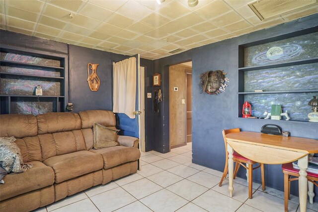 5651 6th St, Zephyrhills, FL 33542 - living area featuring built in shelves and tile patterned flooring