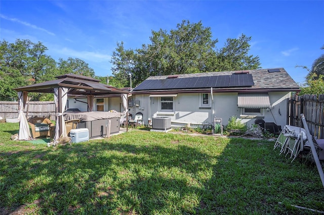 5651 6th St, Zephyrhills, FL 33542 - back of property with roof mounted solar panels and a gazebo