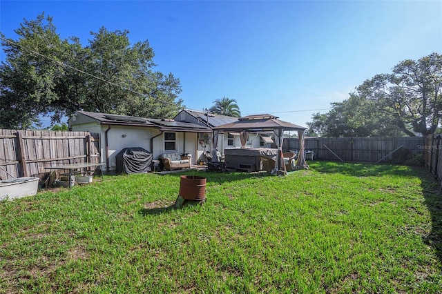 5651 6th St, Zephyrhills, FL 33542 - back of property featuring a fenced backyard, a covered hot tub, stucco siding, a patio, and a gazebo