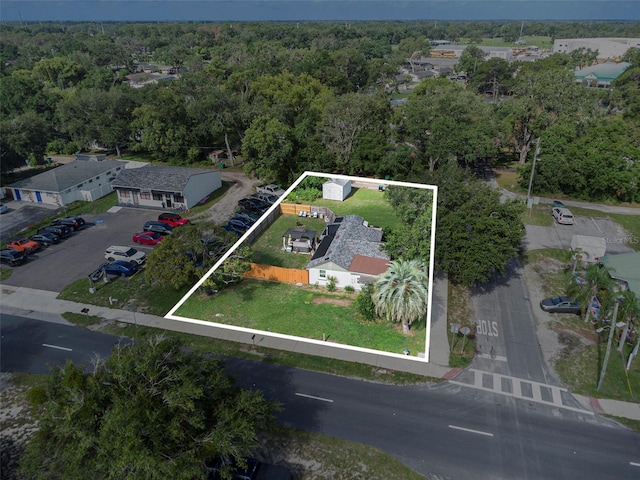 5651 6th St, Zephyrhills, FL 33542 - aerial view of property and surrounding area featuring property parcel outlined and a forest
