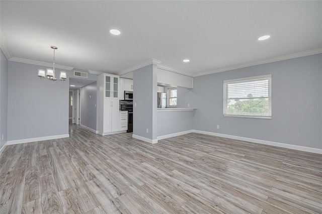 2525 W Bay Dr Unit A46, Largo, FL 33770 - unfurnished living room with a chandelier, ornamental molding, light wood finished floors, and recessed lighting