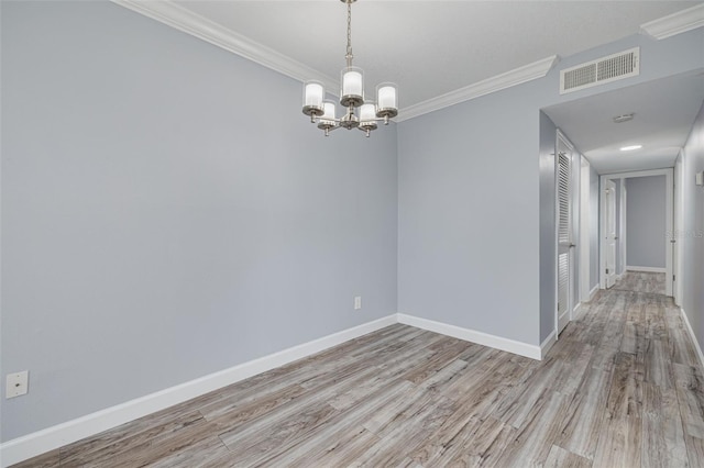 2525 W Bay Dr Unit A46, Largo, FL 33770 - spare room featuring ornamental molding, wood finished floors, a chandelier, and a smoke detector