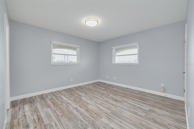 2525 W Bay Dr Unit A46, Largo, FL 33770 - empty room featuring plenty of natural light and wood finished floors