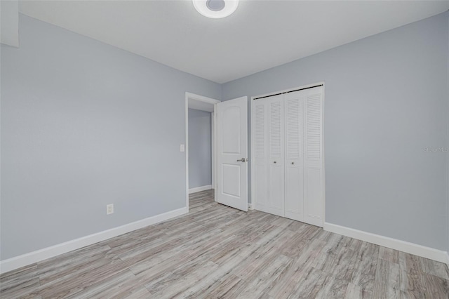 2525 W Bay Dr Unit A46, Largo, FL 33770 - unfurnished bedroom with wood finished floors and a closet