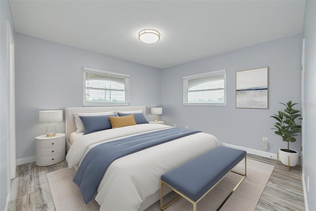 2525 W Bay Dr Unit A46, Largo, FL 33770 - bedroom featuring multiple windows and light wood-style floors
