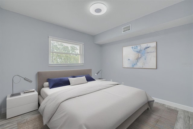 2525 W Bay Dr Unit A46, Largo, FL 33770 - bedroom with light wood-style flooring and baseboards