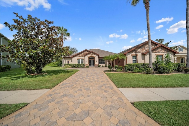 11729 Newberry Grove Loop, Riverview, FL 33579 - mediterranean / spanish-style home featuring a front lawn and stucco siding