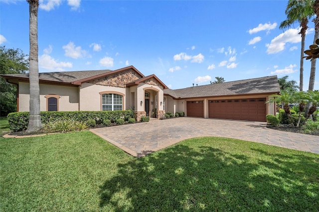 11729 Newberry Grove Loop, Riverview, FL 33579 - view of front of property with an attached garage, decorative driveway, a front lawn, stone siding, and stucco siding