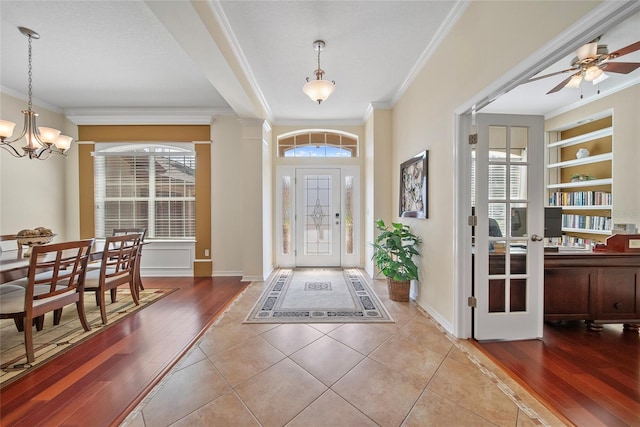 11729 Newberry Grove Loop, Riverview, FL 33579 - entrance foyer with ornamental molding, wood finished floors, a chandelier, and a ceiling fan