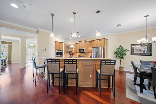 11729 Newberry Grove Loop, Riverview, FL 33579 - kitchen featuring appliances with stainless steel finishes, a chandelier, decorative backsplash, dark wood-type flooring, and crown molding