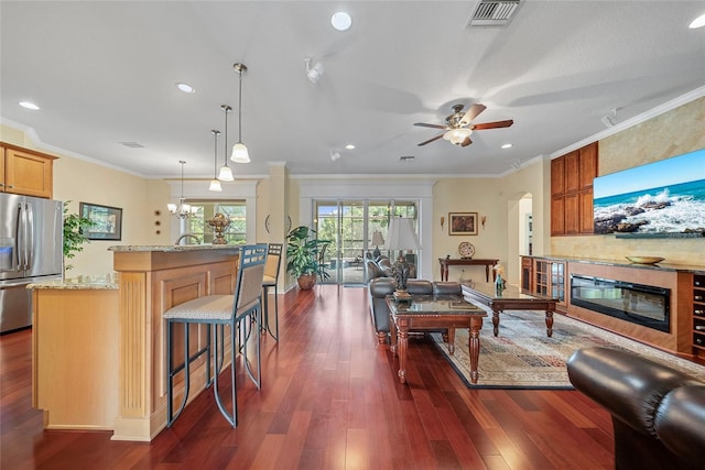 11729 Newberry Grove Loop, Riverview, FL 33579 - living area featuring crown molding, dark wood-style flooring, a ceiling fan, arched walkways, and recessed lighting