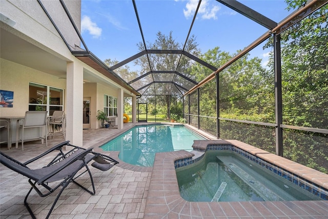 11729 Newberry Grove Loop, Riverview, FL 33579 - view of pool featuring a pool with connected hot tub, glass enclosure, and a patio area
