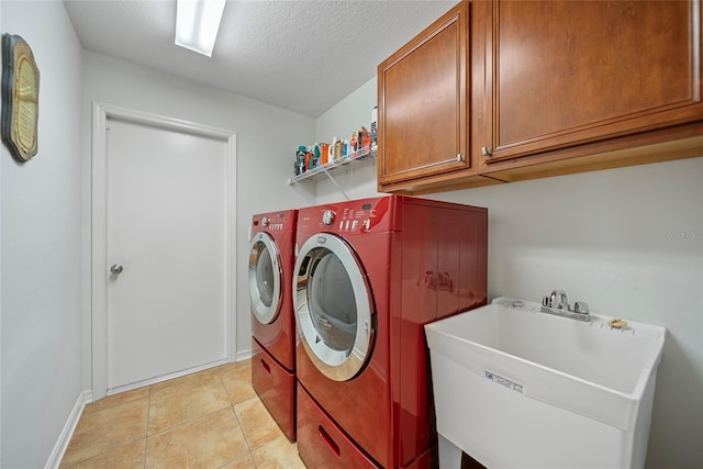11729 Newberry Grove Loop, Riverview, FL 33579 - laundry area featuring washer and dryer, cabinet space, a textured ceiling, and light tile patterned floors