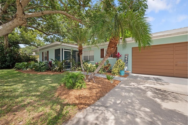 1711 N Highland Ave, Clearwater, FL 33755 - view of front of property featuring a garage, stucco siding, driveway, and a front yard