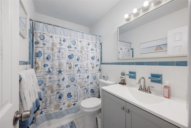1711 N Highland Ave, Clearwater, FL 33755 - full bath featuring tile walls, vanity, tile patterned floors, a shower with curtain, and a wainscoted wall