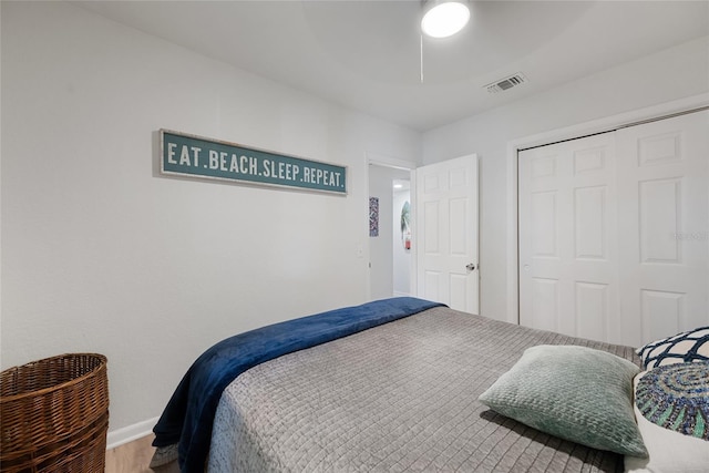 1711 N Highland Ave, Clearwater, FL 33755 - bedroom featuring a closet, wood finished floors, and a ceiling fan