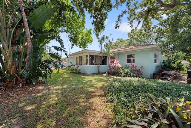 1711 N Highland Ave, Clearwater, FL 33755 - view of green lawn featuring a sunroom
