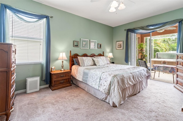 3246 Brenford Pl, Land O Lakes, FL 34638 - bedroom featuring light colored carpet, access to outside, multiple windows, and ceiling fan