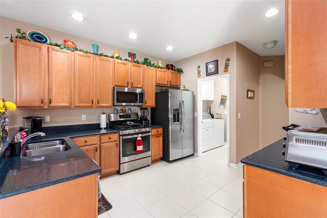 3246 Brenford Pl, Land O Lakes, FL 34638 - kitchen featuring appliances with stainless steel finishes, separate washer and dryer, light tile patterned floors, and recessed lighting