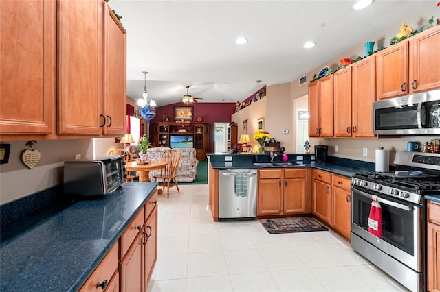 3246 Brenford Pl, Land O Lakes, FL 34638 - kitchen with appliances with stainless steel finishes, a peninsula, ceiling fan, recessed lighting, and brown cabinetry