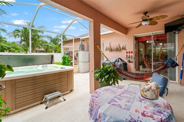 3246 Brenford Pl, Land O Lakes, FL 34638 - view of patio / terrace with a hot tub, a ceiling fan, and glass enclosure