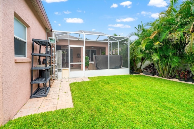 3246 Brenford Pl, Land O Lakes, FL 34638 - rear view of house featuring stucco siding, a yard, and glass enclosure