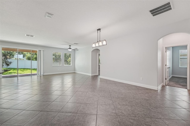 6706 Riverside Bluffs Dr, Riverview, FL 33578 - unfurnished room with arched walkways, tile patterned floors, and ceiling fan