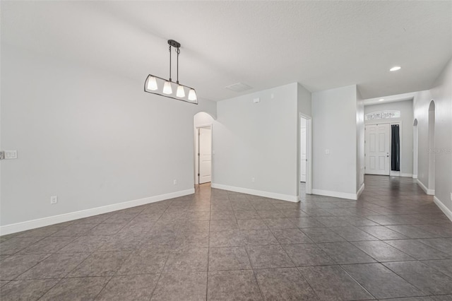 6706 Riverside Bluffs Dr, Riverview, FL 33578 - spare room with arched walkways, dark tile patterned floors, and recessed lighting