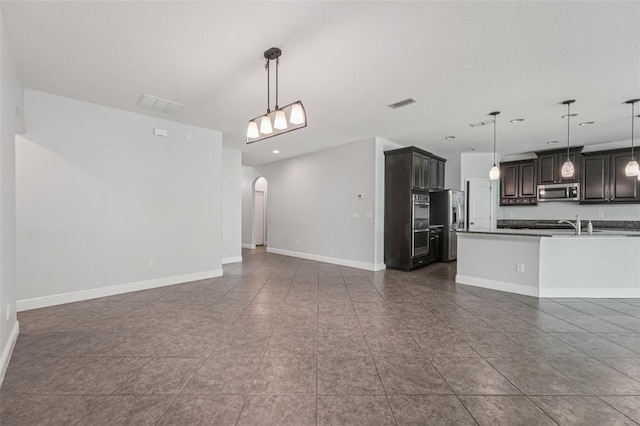 6706 Riverside Bluffs Dr, Riverview, FL 33578 - unfurnished living room featuring arched walkways, recessed lighting, and dark tile patterned flooring