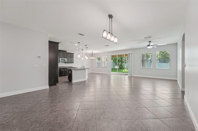 6706 Riverside Bluffs Dr, Riverview, FL 33578 - unfurnished living room featuring ceiling fan, tile patterned floors, and arched walkways