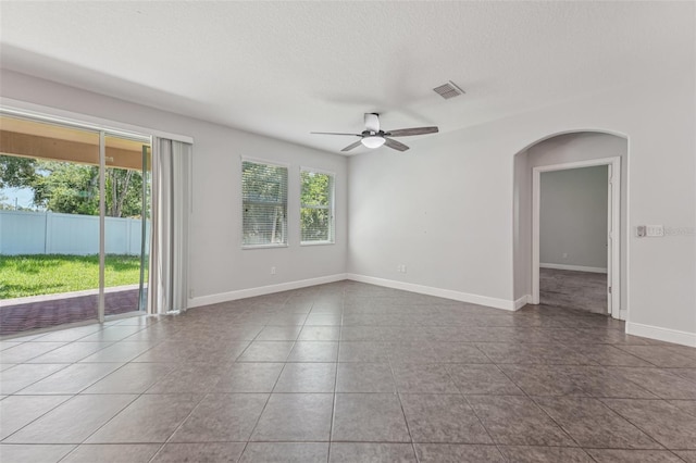 6706 Riverside Bluffs Dr, Riverview, FL 33578 - tiled spare room with ceiling fan, arched walkways, and a textured ceiling