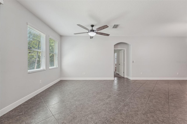 6706 Riverside Bluffs Dr, Riverview, FL 33578 - unfurnished room with ceiling fan, arched walkways, and tile patterned flooring