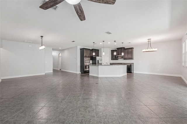 6706 Riverside Bluffs Dr, Riverview, FL 33578 - unfurnished living room with a ceiling fan, dark tile patterned flooring, and recessed lighting