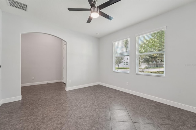 6706 Riverside Bluffs Dr, Riverview, FL 33578 - spare room featuring arched walkways, ceiling fan, and tile patterned floors